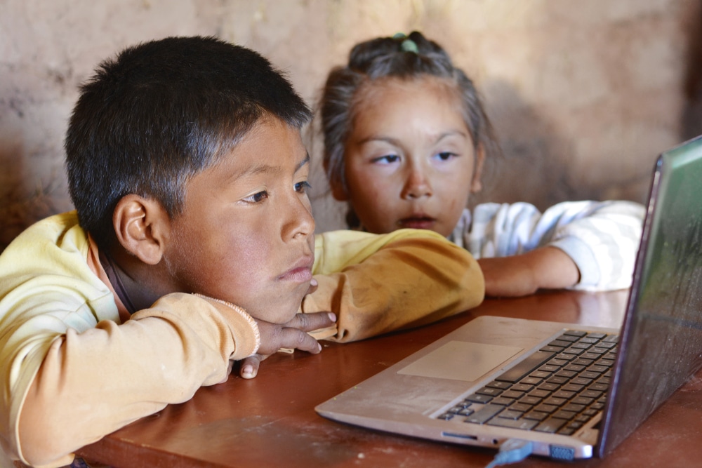 Serious,Native,American,Kids,Using,Notebook.