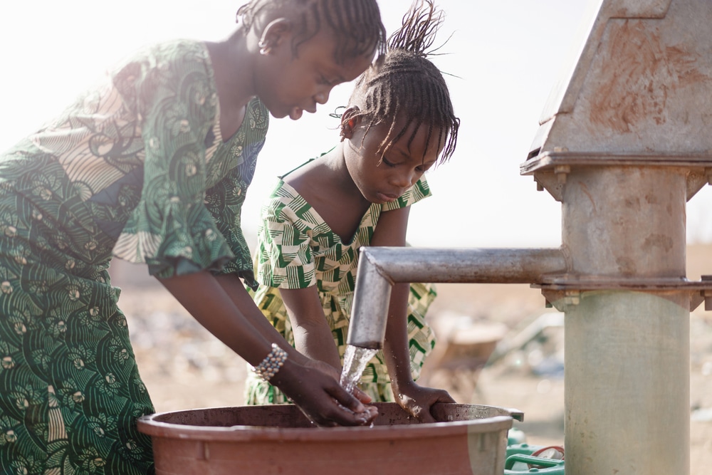 Young,Native,African,Infant,Saving,Crisp,Water,For,A,Lack